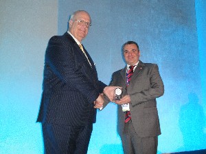 In October, Kent R. Schneider (l), president and chief executive officer of AFCEA International, presents a Meritorious Service Award to Capt. Martin Murray, British Army, Royal Corps of Signals.